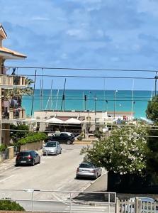 a parking lot with cars parked in front of the ocean at Loft 56 in Porto SantʼElpidio