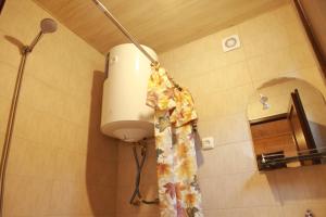 a light in a bathroom with a shower curtain at Cottage Woodside in Mestia +48 photos