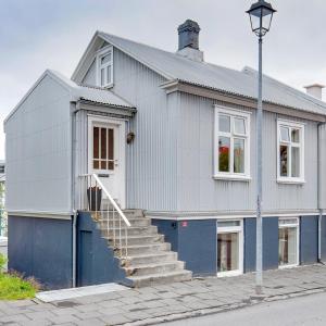 a white and blue house with stairs on a street at Live as Locals Apartments in Reykjavík