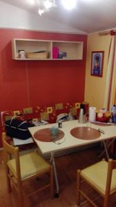 a kitchen with a table and chairs in a room at Vue sur mer in Mers-les-Bains