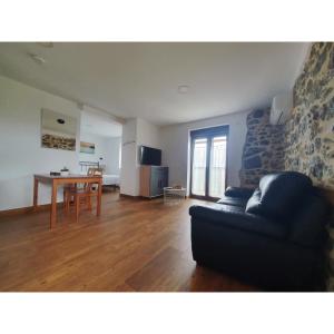 a living room with a couch and a table at VADOS - LA COLINA in Arnuero