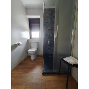 a small bathroom with a toilet and a shower at VADOS - LA COLINA in Arnuero +39 photos