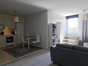a living room with a couch and a table at Terrace Apartments at Kirkkokatu in Savonlinna
