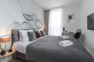 Ένα ή περισσότερα κρεβάτια σε δωμάτιο στο Emihouse Skyline Apartments