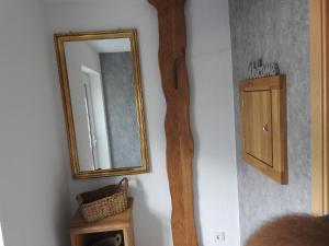a mirror on a wall with a wooden frame at Moselweinlaub in Bruttig-Fankel