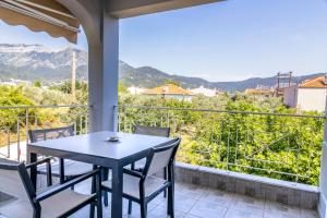 a table and chairs on a balcony with a view at SK Suites Thassos in Skala Potamias