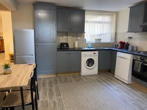 a kitchen with a washing machine and a dishwasher at Seafront, Cleethorpes apt’s in Cleethorpes