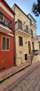 a white and orange building on a cobblestone street at Casa Letizia in San Vito Chietino