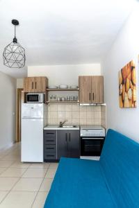 a kitchen with a white refrigerator and a stove at SK Suites Thassos in Skala Potamias