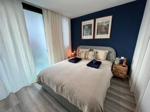 a bedroom with a bed with two pillows on it at MedanoJoy1- 3 bedrooms, spacious apartment 60 m from the beach in El Médano
