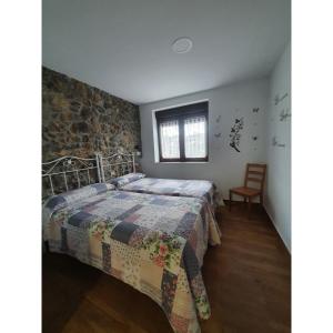 um quarto com uma cama com uma colcha em PORTILLO - LA COLINA em Arnuero