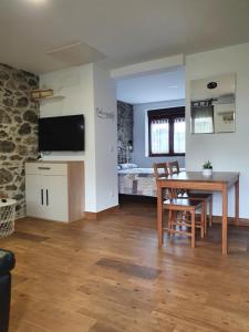 a living room with a table and a bedroom at PORTILLO - LA COLINA in Arnuero