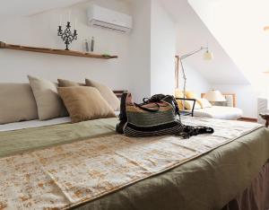 a room with a bed with a couch and a bag on it at Bellagio Retreat lake view apartment in Limonta