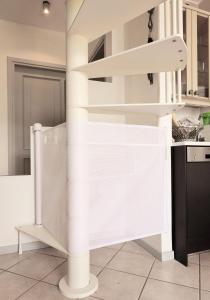 a white spiral staircase in a kitchen at Bellagio Retreat lake view apartment in Limonta +64 photos