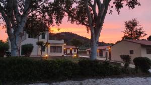 a house with a sunset in the background at Podere Il Ritorno in Portoferraio