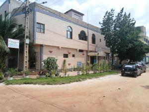 a building with a car parked in front of it at Marys Guest House in Lomé