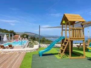 a playground with a slide next to a pool at Villa Despina - Marathia View Private Luxury Villa in Marathias