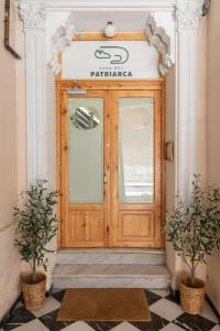 a wooden door in a building with two potted plants at Casa del Patriarca in Valencia