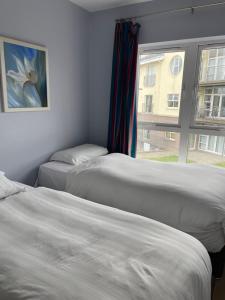 a room with two beds and a window with a painting at Five bedroom waterfront house in Carrick on Shannon +1 photo