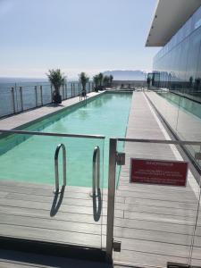 a swimming pool on top of a building with a sign at Hotel Alto Antofagasta in Antofagasta