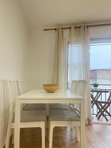 einen Tisch mit Stühlen und eine Schüssel darüber in der Unterkunft Apartamento el Cim, al centro de Arbúcies in Arbúcies