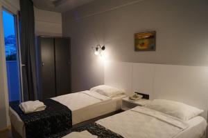 Postel nebo postele na pokoji v ubytování Aslan Sand & City Hotel