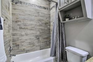 a bathroom with a tub and a toilet and a sink at Gorgeous Edinburg Getaway about 2 Mi to UTRGV! in Edinburg