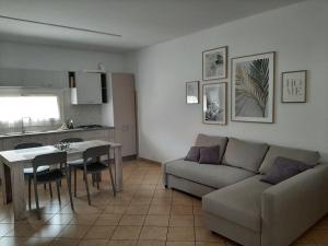 a living room with a couch and a table at Sotto il Portico Home in Tezze sul Brenta