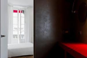 a room with a white wall and a red curtain at Palazzo Segreti in Milan