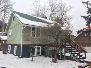 a house with a green roof in the snow at Banff Beaver Cabins in Banff