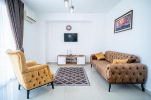 a living room with two couches and a tv at Beautiful Two-bedroom Apartment with Sea and Mountain views Sel 8-5 in Kyrenia +4 photos