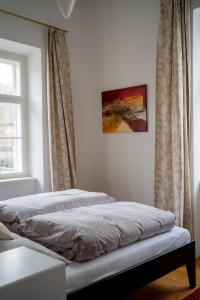 a bed sitting in a room with a window at Ferienwohnung Sandwirtin in Schwanberg