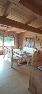 a room with a table and chairs in a house at Gościniec Dziubasowki in Nowy Targ