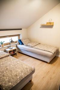 a bedroom with two beds and a window at Apartamenty z tarasami - Moja Gdynia in Gdynia