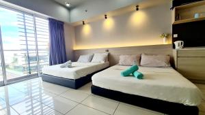 a bedroom with two beds and a large window at Aeropod 2 Queen Bed Near Airport & KK city Free Parking Netflix in Kota Kinabalu +8 photos