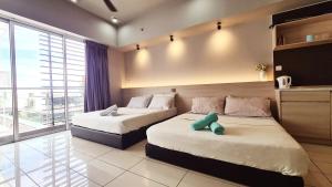 a bedroom with two beds and a large window at Aeropod 2 Queen Bed Near Airport & KK city Free Parking Netflix in Kota Kinabalu