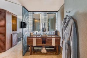 a bathroom with a sink, mirror, and bathtub at Live Aqua Beach Resort Cancun in Cancún