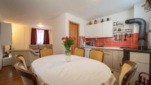 a kitchen with a table with a vase of flowers on it at Holiday Home Kokot in Ravna Gora