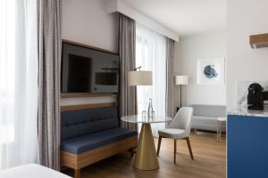 a hotel room with a bed and a table at Sheraton Nice in Nice
