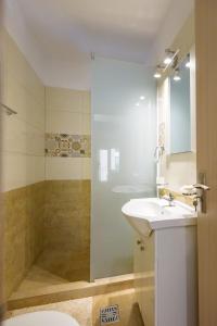 a bathroom with a toilet and a sink and a shower at SaloS Beach Resort in Mamaia Sat/Năvodari +45 photos