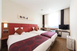 Postel nebo postele na pokoji v ubytování HOTEL MYSTAYS Haneda