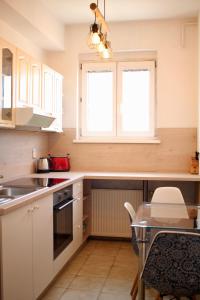 a kitchen with white cabinets and a table at Top Floor Manderla in Bratislava +10 photos