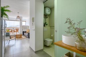 a bathroom with a tub and a sink in a room at Stylish Sea View Accommodation Las Canteras in Las Palmas de Gran Canaria