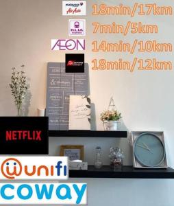 a shelf with a clock and signs on a wall at Family stay, sepang KLIA, free 2 parking&Unifi in Sepang