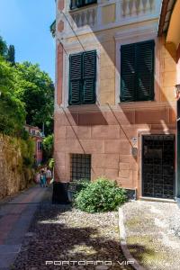 a building with green shutters on the side of it at San Giorgio by PortofinoVip in Portofino