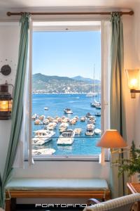 a window with a view of boats in the water at San Giorgio by PortofinoVip in Portofino