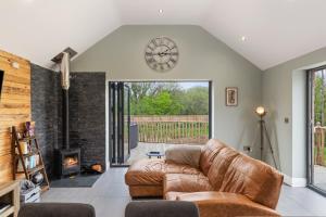 a living room with a couch and a fireplace at Fig Tree Cottage in Tenby