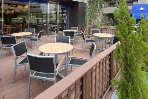 a row of tables and chairs on a balcony at HOTEL MYSTAYS Haneda in Tokyo