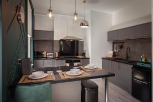 a kitchen with a table with dishes on it at Town View Apartment by Sasco in Blackpool