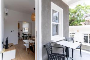 a living room with a table and chairs and a window at Villa Italic in Antalya